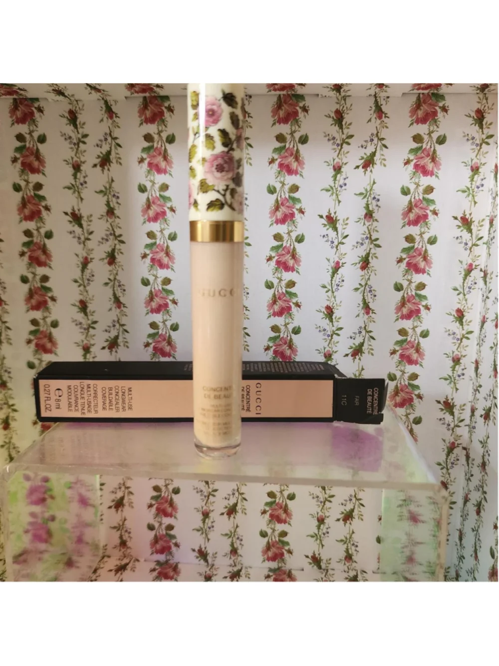 Gucci concealer with pink and green floral design on white background #gucci #fl
